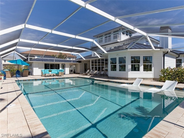 view of pool featuring a patio area and glass enclosure