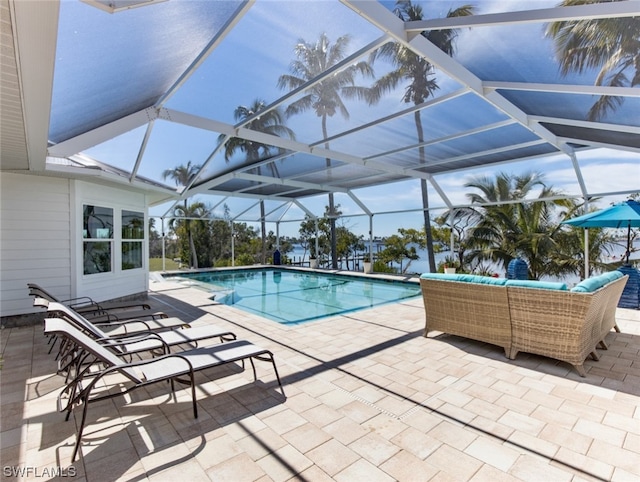 view of pool featuring a patio area and glass enclosure