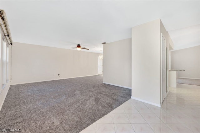 spare room with ceiling fan and light colored carpet