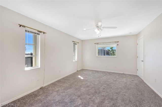 spare room with light carpet, a healthy amount of sunlight, and ceiling fan