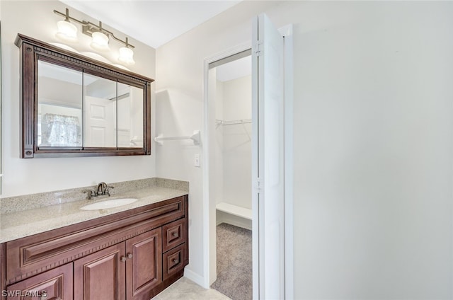 bathroom featuring vanity with extensive cabinet space