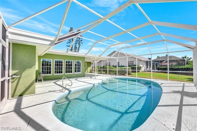 view of swimming pool featuring a patio and a lanai