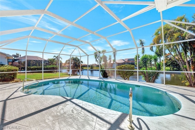 view of swimming pool featuring a lawn, a patio, and glass enclosure