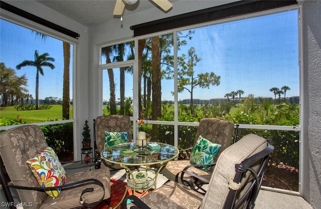 sunroom / solarium featuring ceiling fan