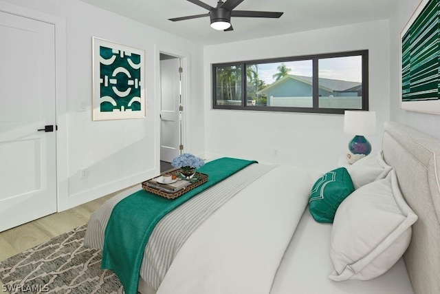 bedroom with ceiling fan and wood-type flooring