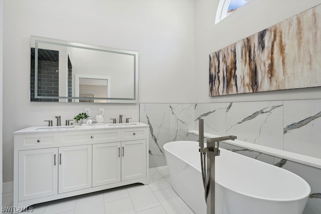 bathroom with tile patterned flooring, tile walls, a bathtub, and vanity