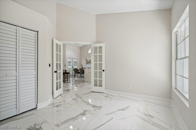 unfurnished bedroom with french doors and a closet