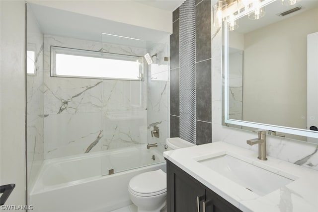 full bathroom featuring vanity, toilet, and tiled shower / bath combo