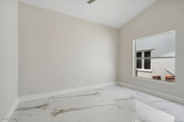 spare room featuring vaulted ceiling and ceiling fan