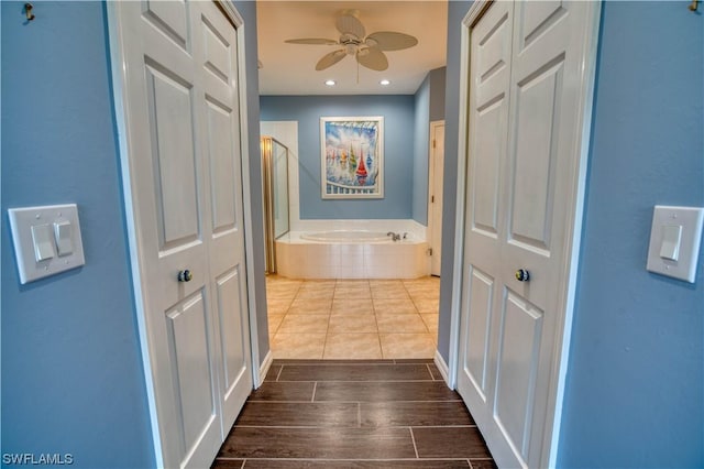 bathroom featuring ceiling fan and separate shower and tub