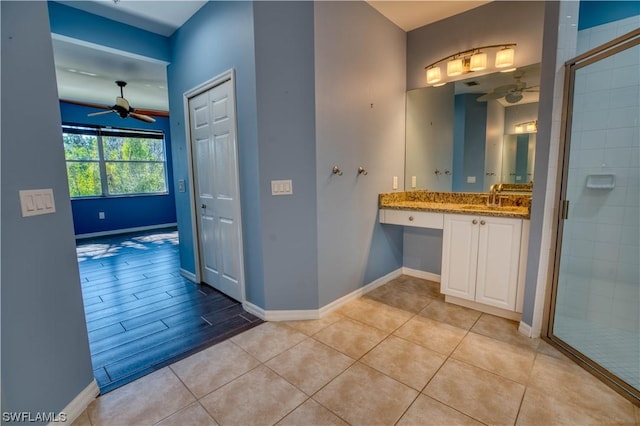 bathroom with walk in shower, tile patterned floors, vanity, and ceiling fan