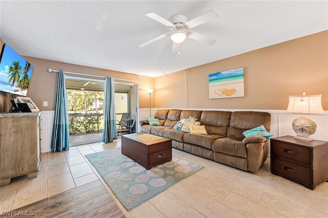 tiled living room with a textured ceiling and ceiling fan