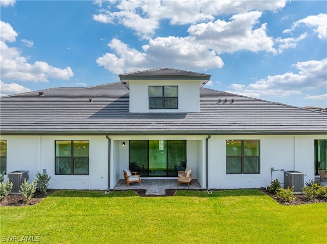 back of house featuring a yard, a patio area, cooling unit, and stucco siding