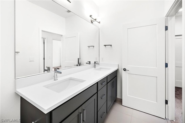 bathroom with tile patterned floors and vanity