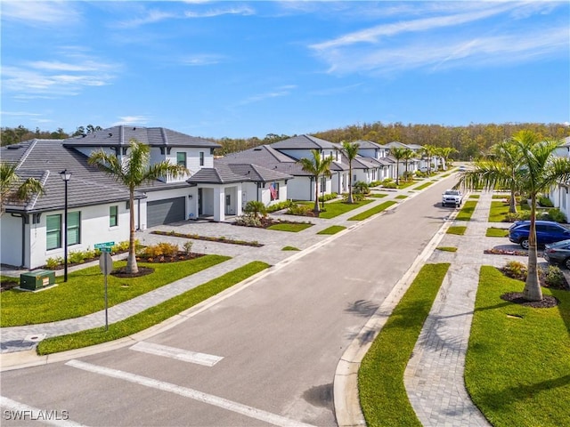 view of road with sidewalks, a residential view, and street lighting