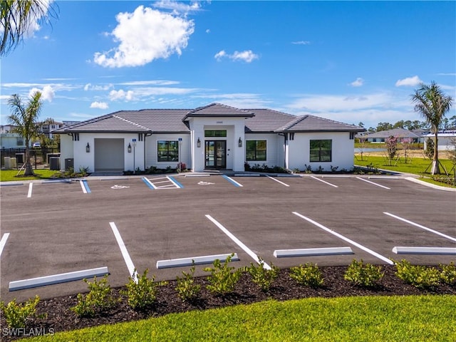 uncovered parking lot featuring french doors