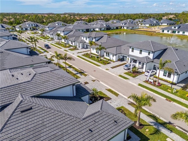 drone / aerial view with a residential view and a water view