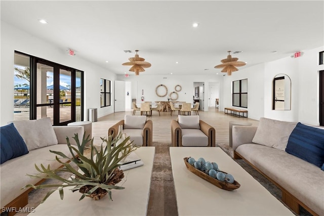 living room featuring wood finished floors, recessed lighting, french doors, and visible vents