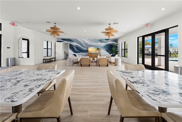 dining room with recessed lighting, visible vents, french doors, and light wood-type flooring