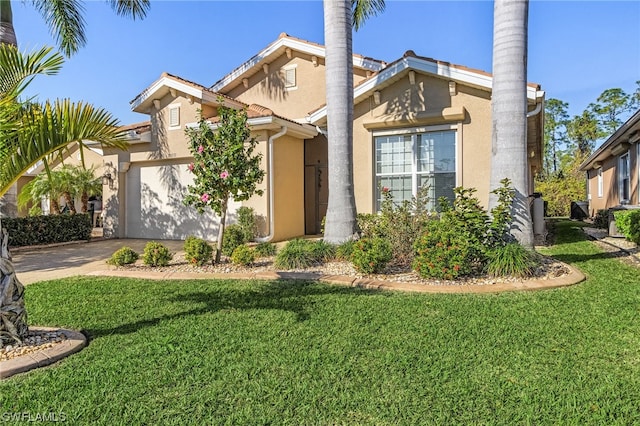 view of front of house featuring a front yard and a garage