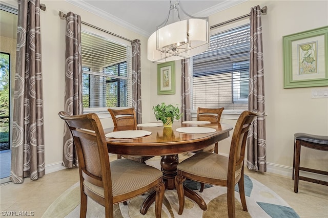 dining room featuring ornamental molding, light tile patterned floors, and a chandelier