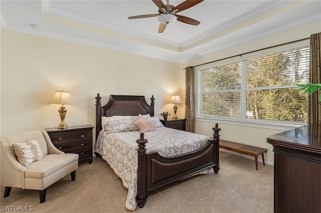 bedroom featuring multiple windows, crown molding, light carpet, and a tray ceiling