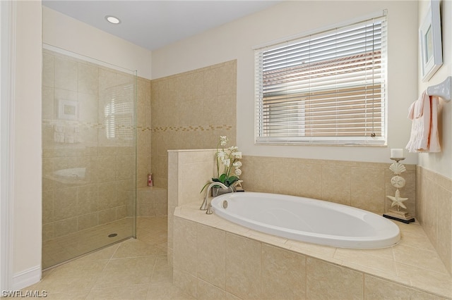 bathroom featuring independent shower and bath and tile patterned flooring