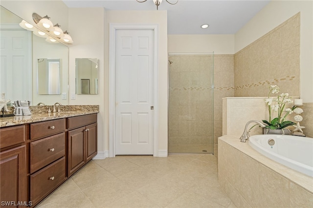 bathroom featuring vanity, plus walk in shower, and tile patterned flooring