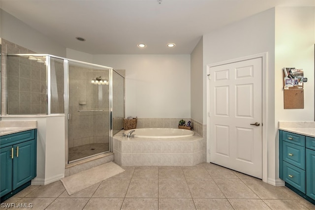 bathroom featuring vanity, tile flooring, and separate shower and tub