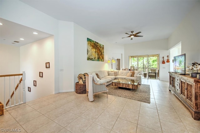 living room featuring light tile floors and ceiling fan