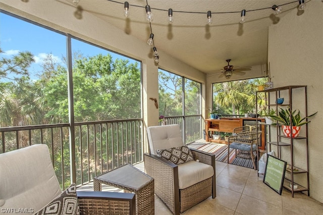 sunroom with ceiling fan and track lighting