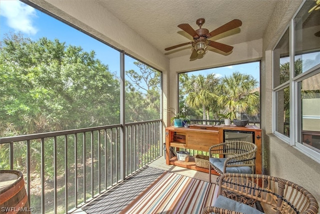 sunroom with ceiling fan and a wealth of natural light