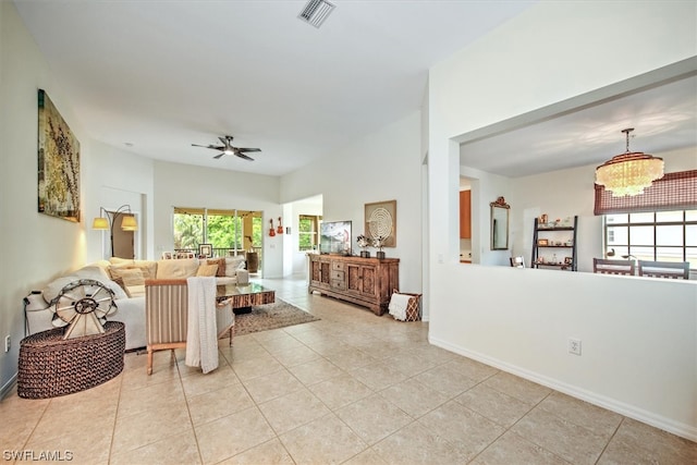 interior space featuring ceiling fan with notable chandelier