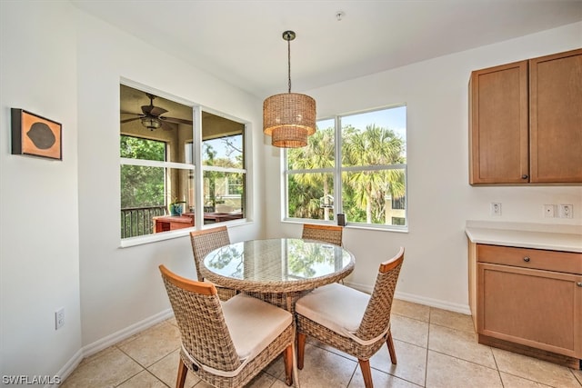 dining area featuring ceiling fan and light tile floors