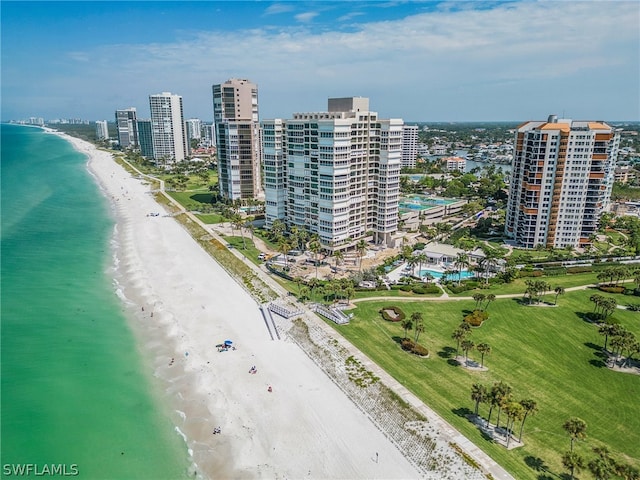 birds eye view of property featuring a water view and a beach view