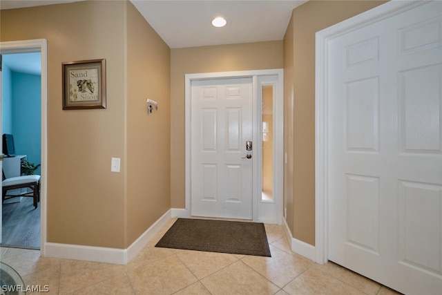 foyer entrance with light tile patterned floors