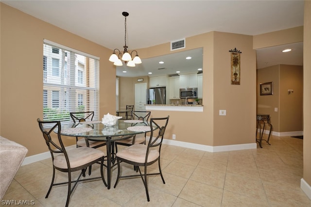 dining space featuring an inviting chandelier and light tile patterned floors