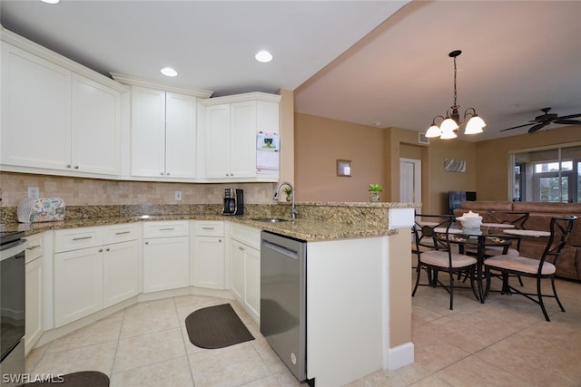 kitchen featuring stainless steel dishwasher, ceiling fan with notable chandelier, white cabinetry, and kitchen peninsula