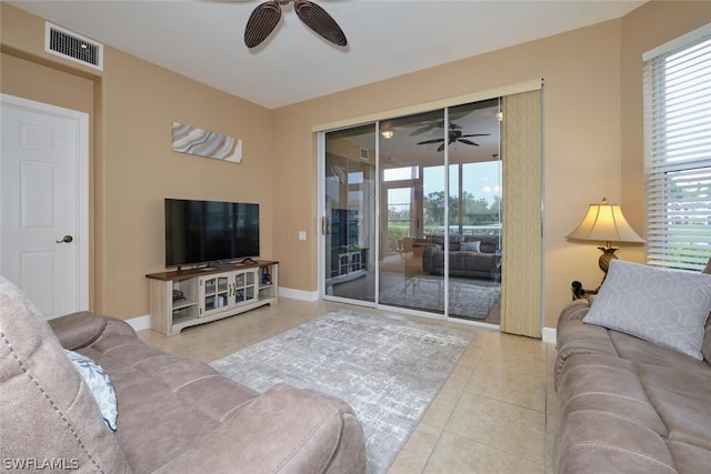 living room with ceiling fan and light tile patterned floors