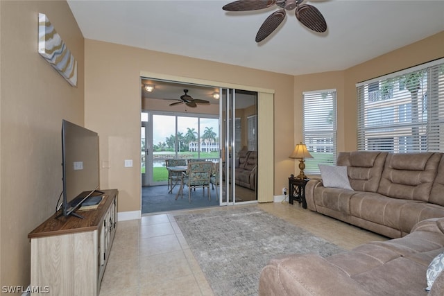 living room featuring ceiling fan and light tile patterned floors