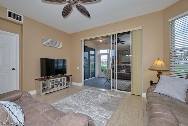 tiled living room featuring ceiling fan