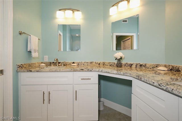 bathroom with tile patterned flooring and vanity