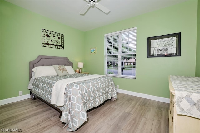 bedroom with ceiling fan and light wood-type flooring