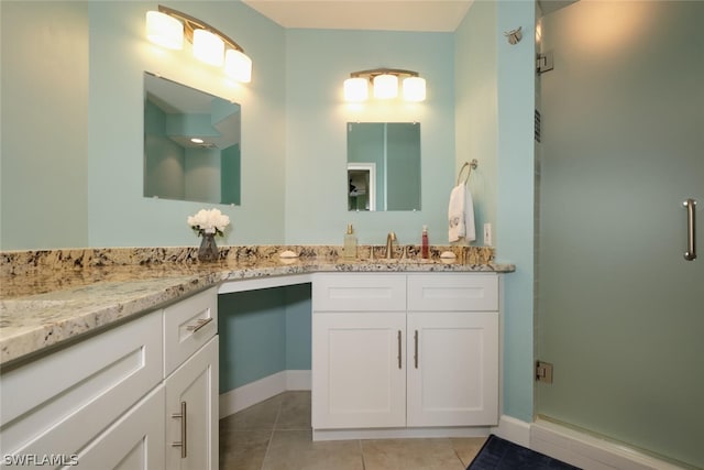 bathroom featuring an enclosed shower, tile patterned flooring, and vanity