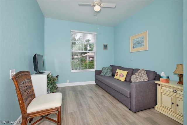 living room featuring ceiling fan and light hardwood / wood-style flooring