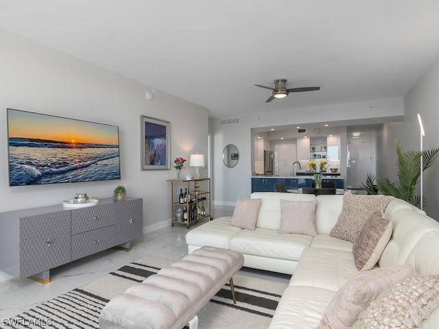 living room with ceiling fan and sink