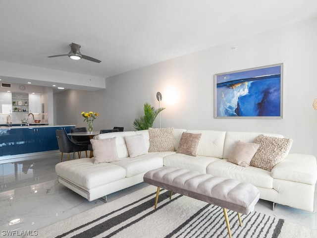 living room featuring ceiling fan and sink