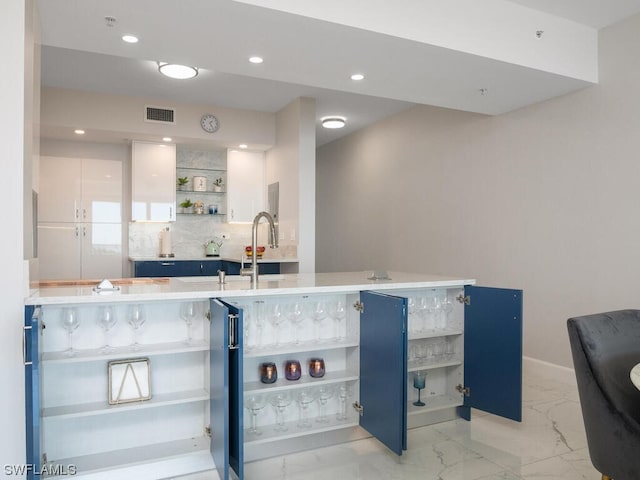 interior space featuring sink and tasteful backsplash