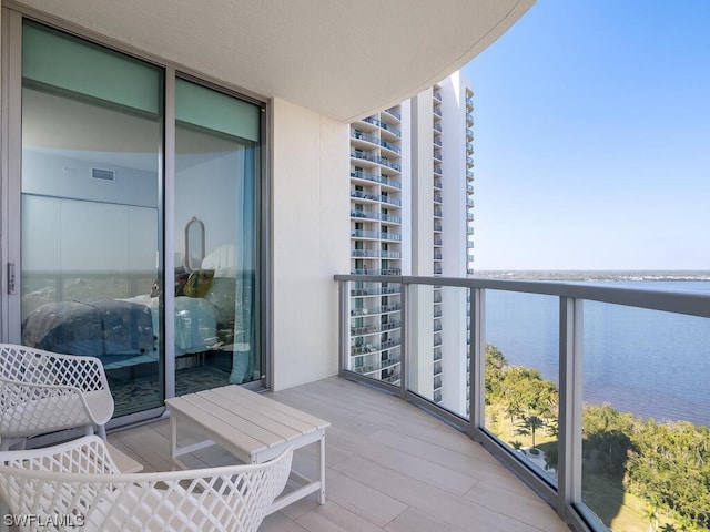 balcony featuring a water view