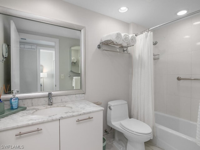 full bathroom featuring shower / bath combination with curtain, vanity, and toilet